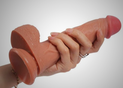 Realistic silicone vibrator held in hand, perfect to buy women's sex toys online